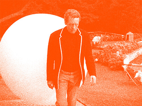 The main character from the Prisoner, with the Rover sphere in the background